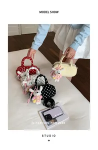 Korean style polka dot bowling bag with cute plush bunny keychain, stylish shoulder handbag.