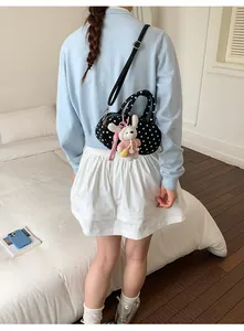 Korean style polka dot shoulder bag with cute bunny pendant for sweet daily look.