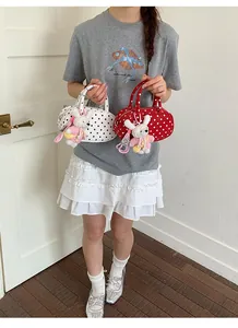Detail view of Korean polka dot bowling handbag with cute rabbit pendant for women.