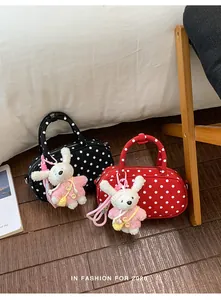 Polka dot handbag detail featuring a cute plush bunny pendant in a sweet Korean style.