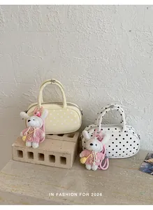 Detailed view of Korean style polka dot bowling handbag with cute knit bunny rabbit pendant.