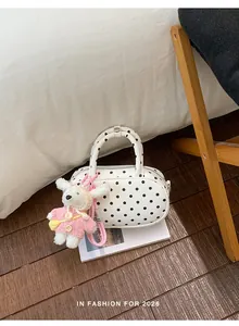 White black polka dot bowling handbag with plush doll charm, trendy PU leather daily shoulder bag.