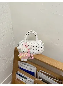 Korean style polka dot crossbody bowling bag with cute plush charm, chic and trendy detail.