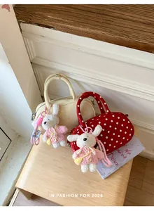 Detailed view of cute polka dot bowling handbag with knitted rabbit pendant for sweet style.