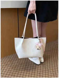 Elegant white textured leather commuter tote bag with cute bear charm for women