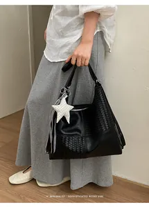 Bolso tote grande de cuero negro con textura tejida y colgante de estrella mujer