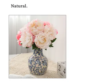 Exquisite artificial peony flower bouquet in a blue white ceramic vase for home decor.