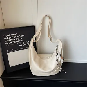 Minimalist beige PU leather hobo shoulder bag with cute horse charm for women daily fashion.