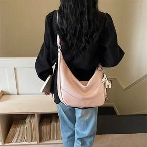Chic pink slouchy shoulder bag for women, trendy dumpling crossbody bag for spring daily wear.