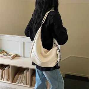 Detailed view of the cream white slouchy hobo dumpling shoulder bag, casual everyday style.