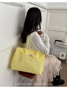Detail view of yellow jelly tote bag, stylish daily commuting shoulder bag for women.