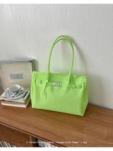 Close-up of the neon green jelly tote bag showcasing its spacious interior and chic lock design.