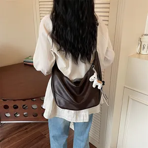 Brown leather shoulder underarm dumpling bag with cute horse charm for women spring chic