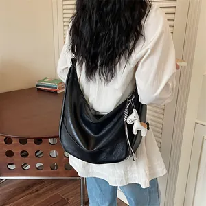 Black PU leather hobo shoulder bag for women with cute horse charm casual dumpling crossbody.