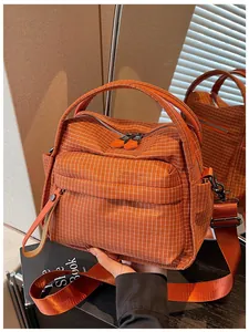 Orange plaid waterproof oxford cloth crossbody bag with top handles and wide shoulder strap.