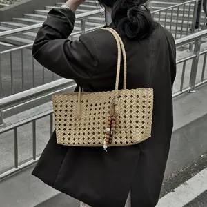 Stylish hollow-out tote bag for women, large capacity summer beach bag with charm.