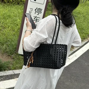 Black woven tote bag detail view, casual large capacity shoulder bag for women daily commuting.