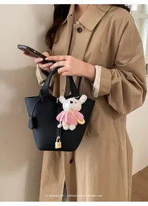 Elegant black bucket bag for women, chic retro design with cute bear pendant and lock.