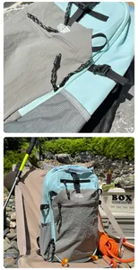 Detailed view of hiking backpack showing nylon fabric textures and durable zipper pulls