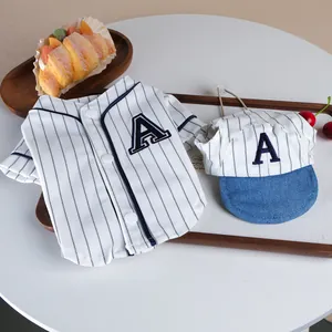 Close-up detail view of the pet baseball jersey and matching cap with stylish stripes.