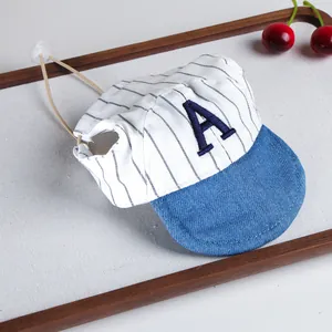Pet baseball hat detail showing blue denim brim, white striped fabric, and cute letter design.