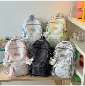 Fashionable tie-dye student backpacks in five pastel colors with cute plush animal keychains.