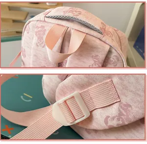 Close-up of pink student backpack showing sturdy top handle and adjustable strap buckle