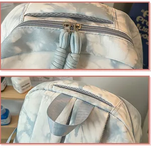 Detailed close-up of a tie-dye backpack showing dual zippers and a sturdy top handle