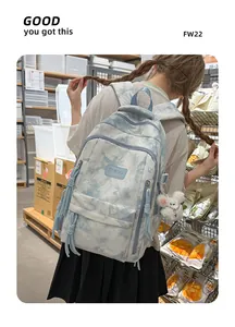 Detailed view of tie-dye student backpack with cute plush bear keychain charm