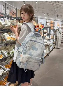 Lifestyle shot of a student wearing a trendy tie-dye backpack inside a store setting.