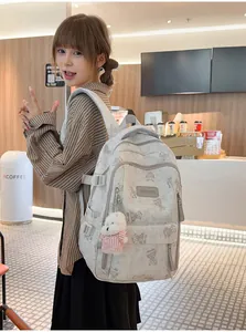 Asian student model wearing a cute bear print large capacity school backpack in a cafe