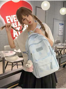 Cute light blue schoolbag featuring bear prints and a plush dog charm worn by a girl