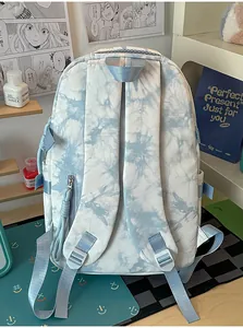 Back view detail of tie-dye school backpack featuring padded shoulder straps and top handle