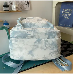 Detailed view of the blue and white tie-dye patterned backpack with multi-layer pockets