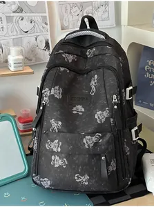Detailed view of the dark student backpack featuring cute bear print and sturdy zippers.