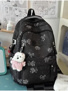 Close-up of black backpack with cute white bear print in a stylish room setting.