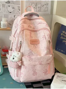 Detail view of pink bear print school backpack with cute plush bear charm