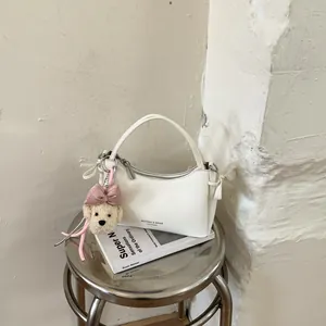 White leather handbag with cute plush puppy charm, stylish top handle mini tote bag for women.