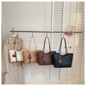 Casual large capacity tote bag for women, stylish shoulder bag with cute bear pendant.