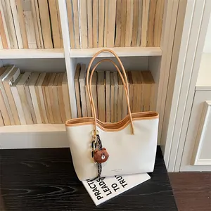 Large capacity white tote bag with brown handles and cute bear pendant for daily casual wear.