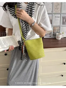 Green woven bucket bag, minimalist single-shoulder crossbody bag for summer chic style.