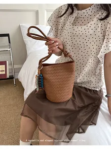 Chic vintage woven bucket bag for women, stylish shoulder crossbody bag for summer chic.