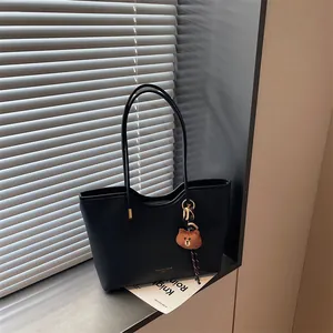 Black large capacity tote bag for women, stylish PU leather shoulder bag with cute bear pendant.