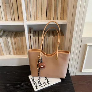 Large capacity beige tote bag for women, stylish PU leather shoulder bag with cute bear charm.