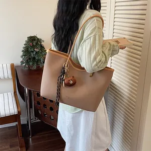 Large capacity brown shoulder tote bag for women, stylish PU leather handbag with cute bear charm.