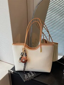 Stylish large capacity tote bag for women with chic design, shoulder bag and cute bear pendant.