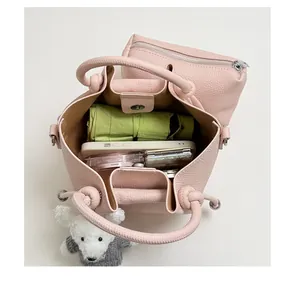 Top-down detail showing the large capacity of the pink pebbled leather bucket bag