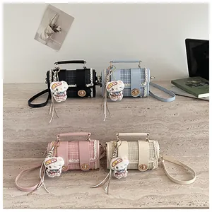 Chic plaid shoulder bag with PU leather trim, lace edge, and cute plush bear pendant for women.
