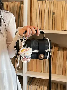 Black plaid shoulder bag with white lace trim and cute plush pendant for women commute.