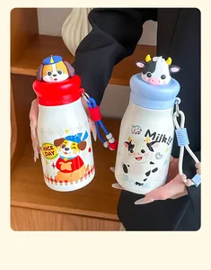 Cute stainless steel insulated water bottle with cartoon doll topper and strap for students and kids.